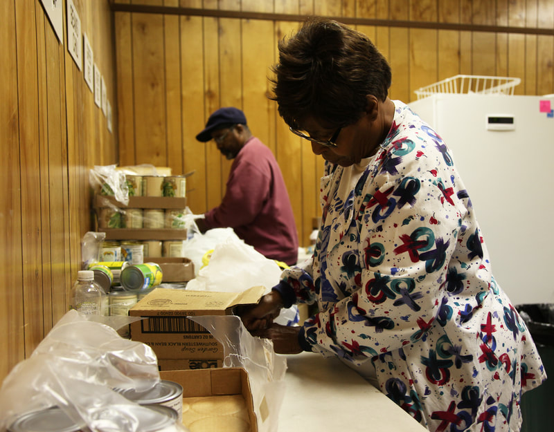 Volunteers break down bulk packages to fill boxes with the compnents of well-rounded meals. The DCCM food pantry functions through community donation and local, state and federal grant monies.