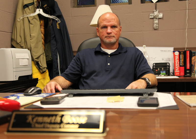 Chief Deputy Coroner Kenneth Boose sits in his office just down the hall from the city/county morgue. The Augusta-Richmond County Coroner's Office handles the daily operations of the paupers' cemetery. 